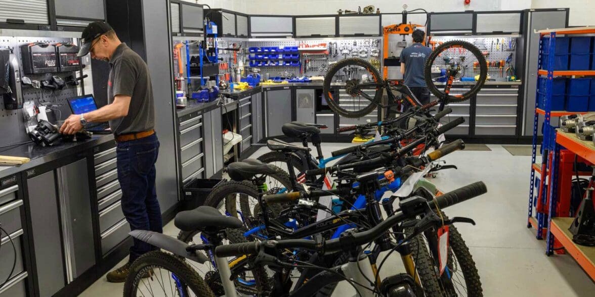 Technicians in workshop service multiple electric bike models