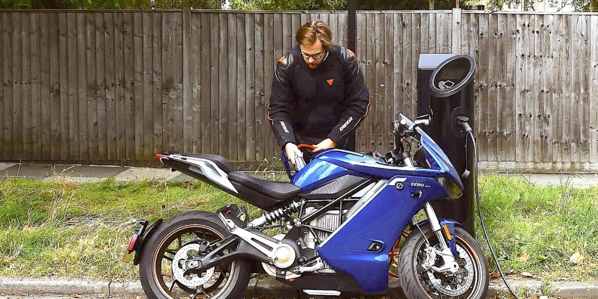 A view of an electric motorcycle plugged in for a charge. Media sourced from Autocar.