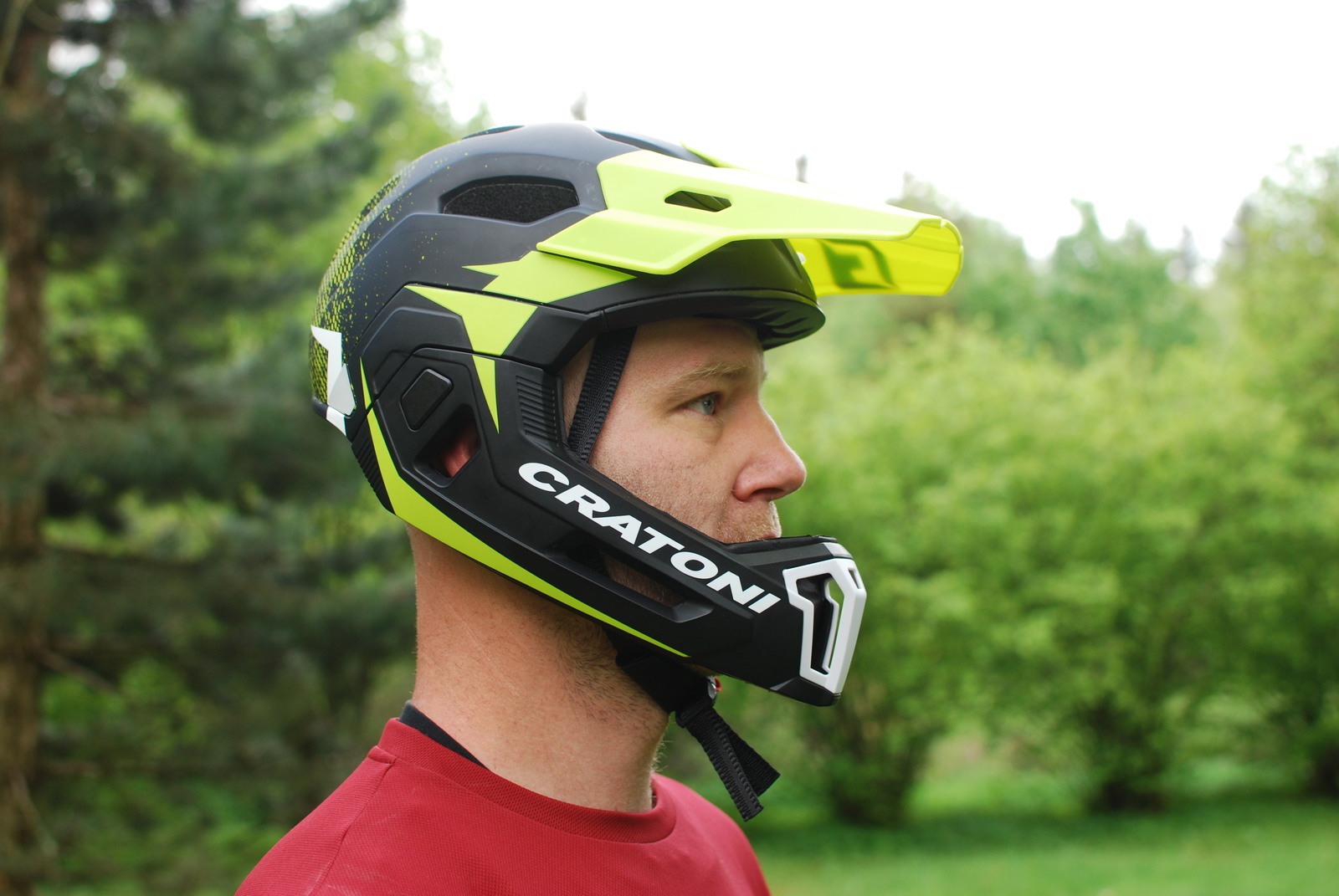 Side profile shot of man wearing C-Maniac Pro mountain bike helmet in garden