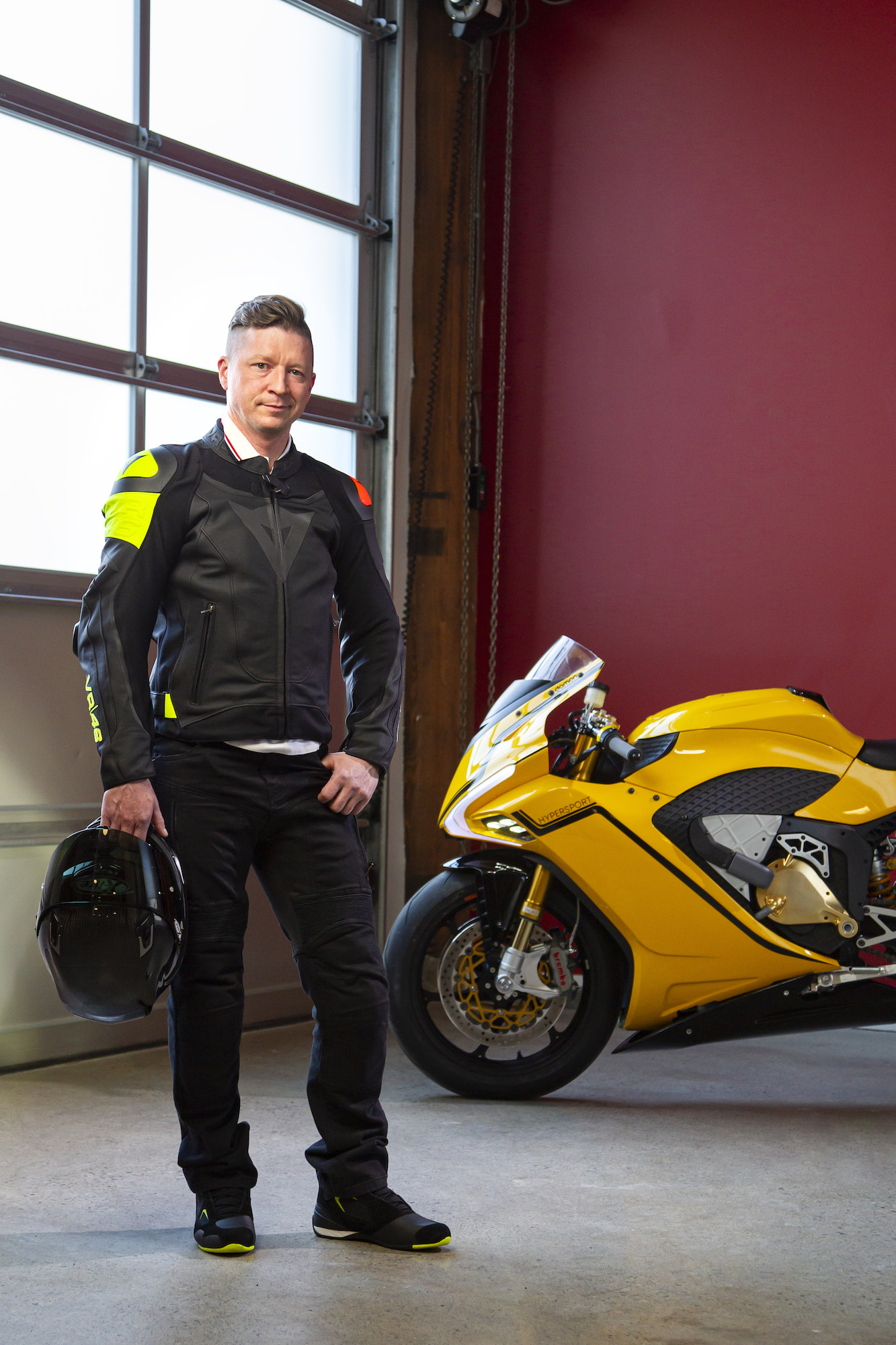 Jay Giraud next to the Damon HyperSport. Media sourced from the team at Damon Motor Ltd.