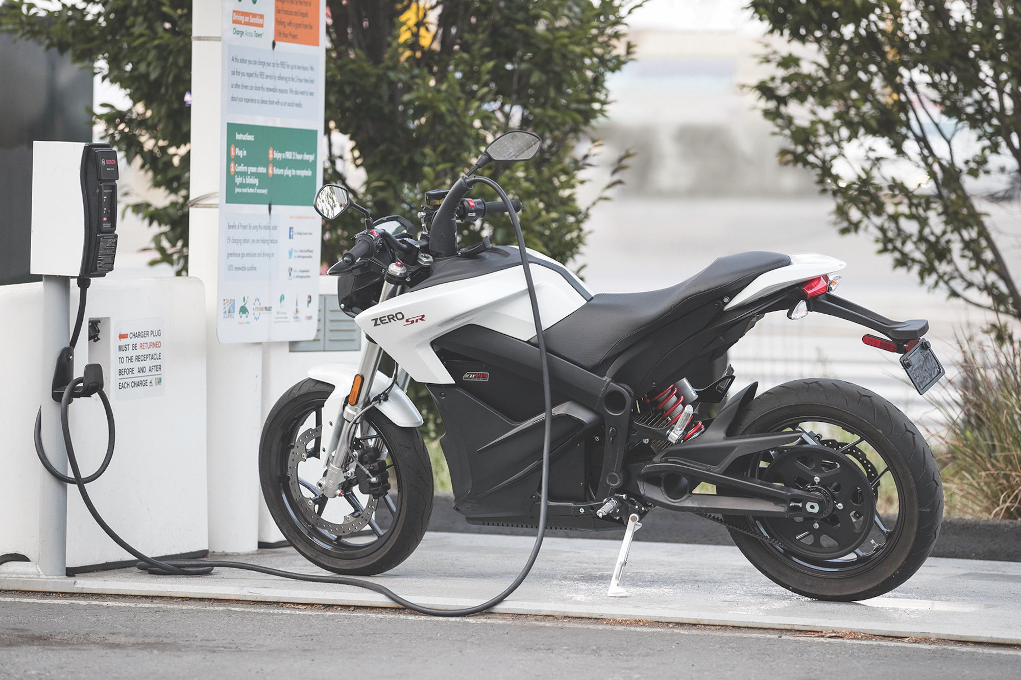 A view of an electric motorcycle plugged in for a charge. Media sourced from GreenFleet.