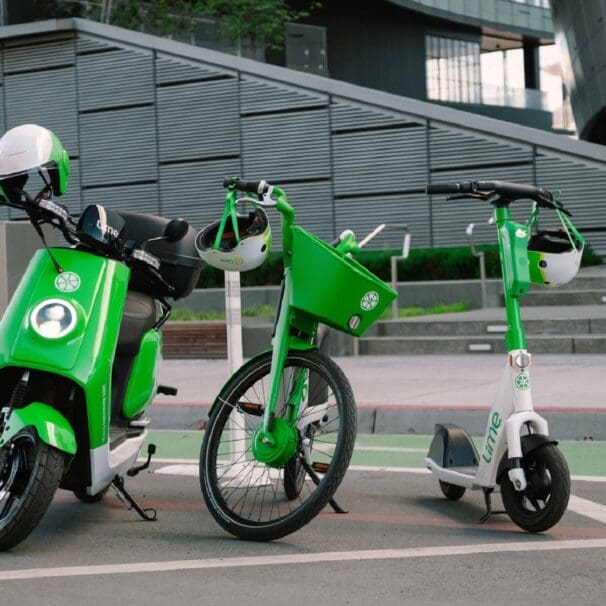 Lime rental electric moped, eBike and eScooter standing together in urban city