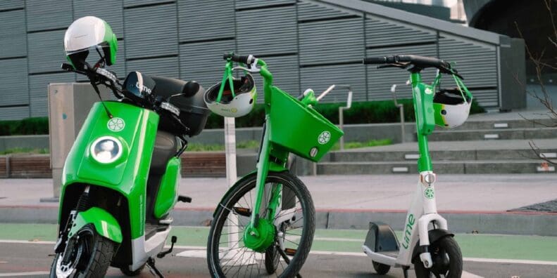 Lime rental electric moped, eBike and eScooter standing together in urban city