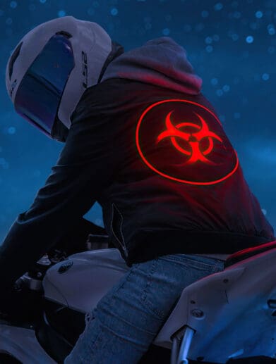 A biker with a biohazard sign on their hoodie. Media sourced from Rare Gallery.