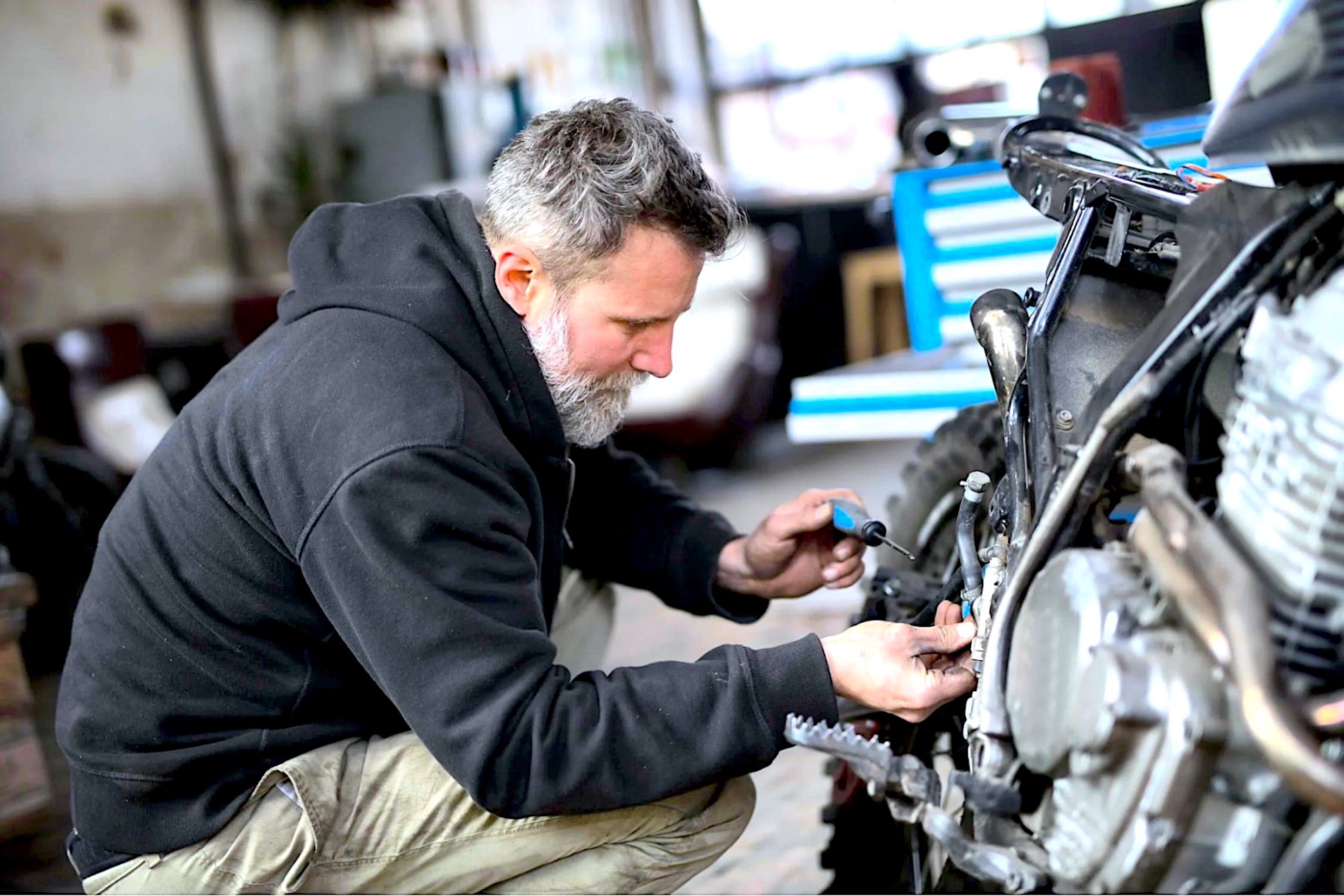 A guy working on a bike.  Media taken from Service Honda.