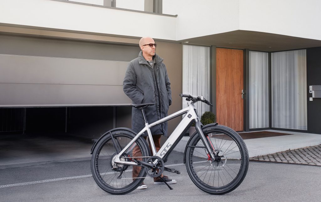 Man stands by Stromer ST5 top-end full-frame electric bike
