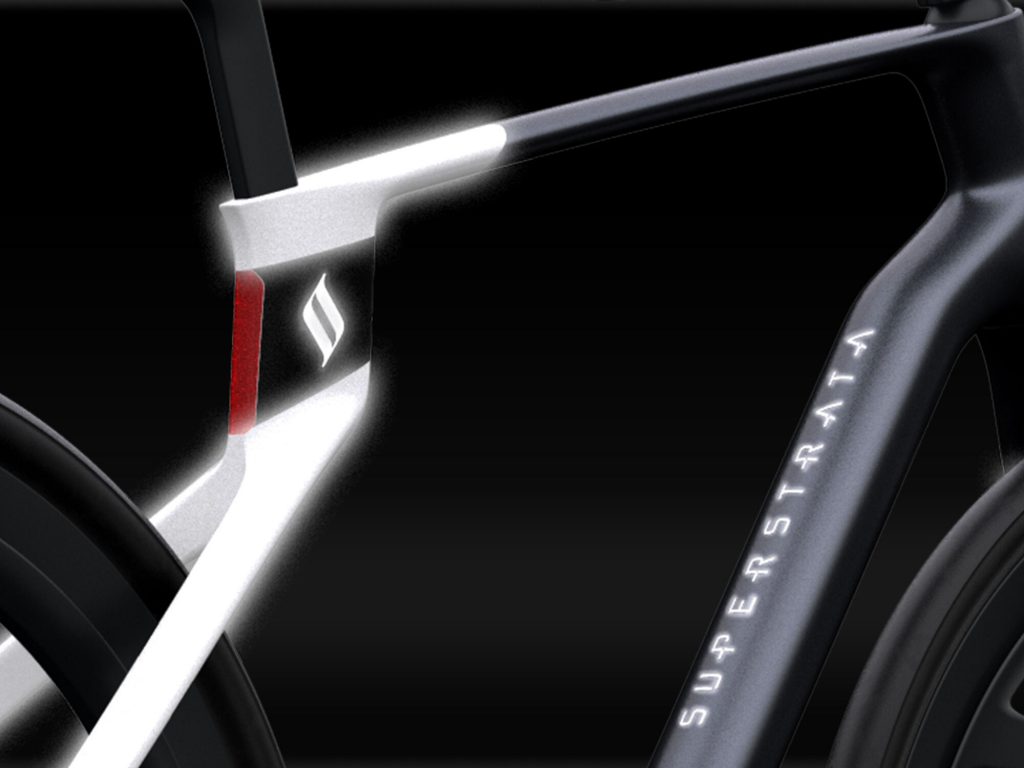 Close-up of glowing Superstrata logo on Time Warp electric bike