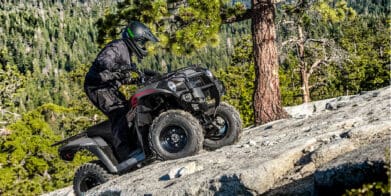 Rider on a 2023 Kawasaki Brute Force 300 climbing up a rockface.