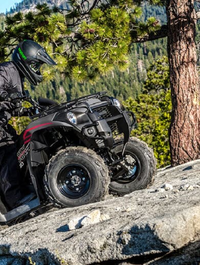 Rider on a 2023 Kawasaki Brute Force 300 climbing up a rockface.