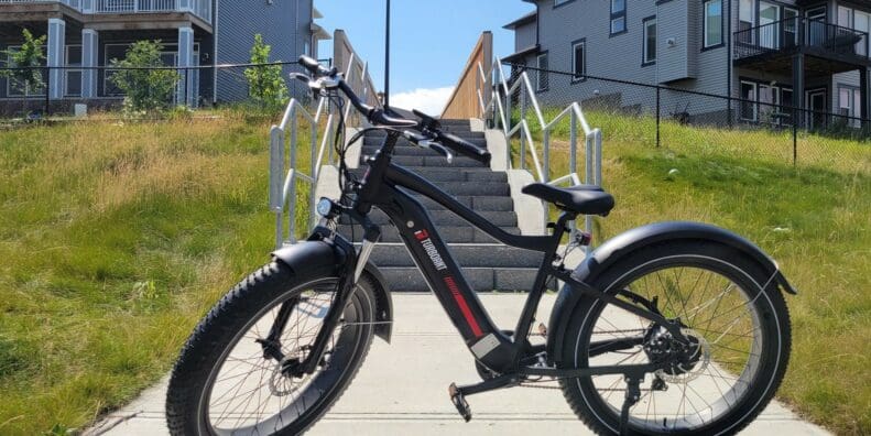 TurboAnt Nebula N1 Electric Bike parked outside near houses