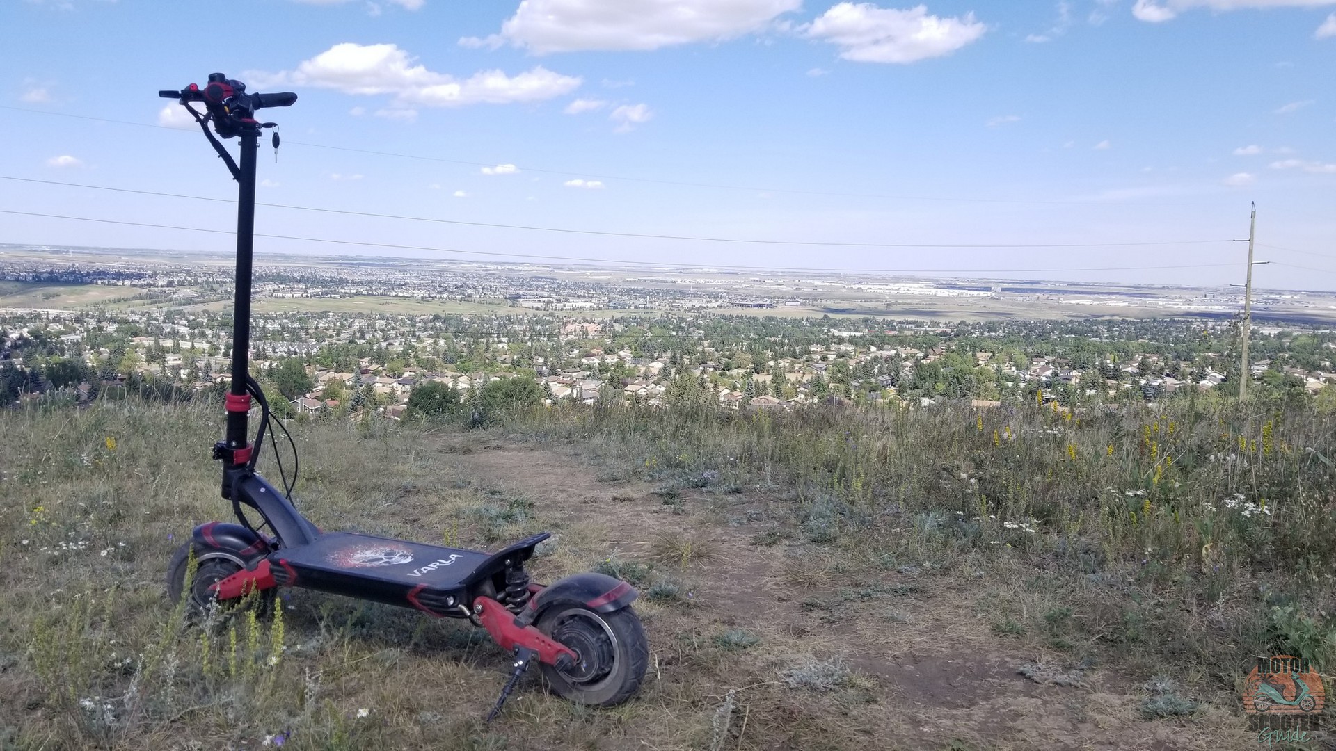 Eagle One scooter at the top of Nose Hill park overlooking the city