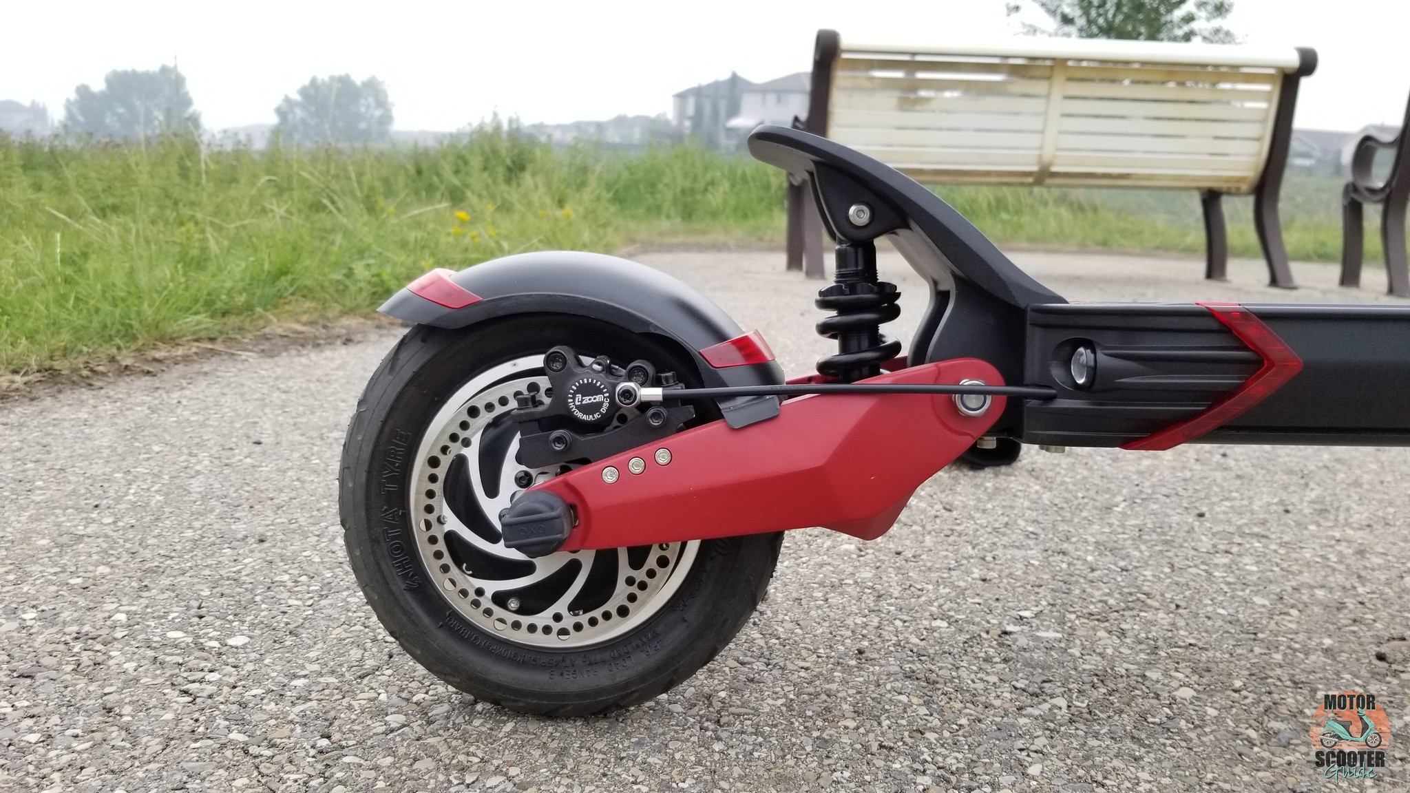 Closeup of rear wheel showing off disc brakes and suspension