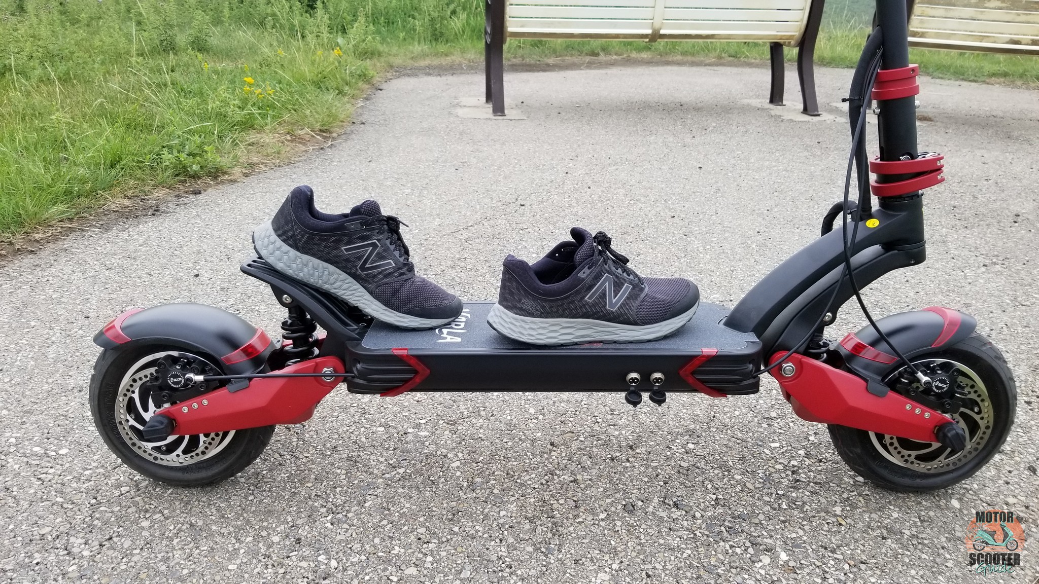 Shoes on the Varla Eagle One scooter simulating riding form
