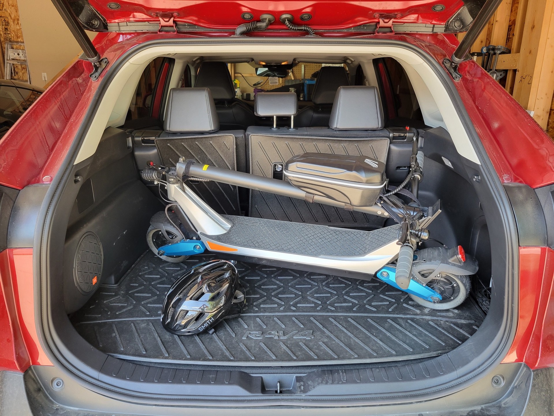 Varla Pegasus Scooter folded and packed in hatchback trunk