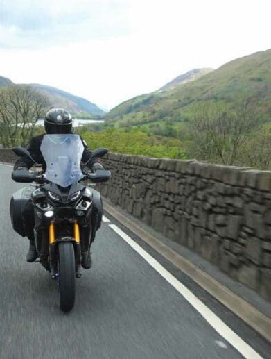 A motorcyclist enjoying cost-per-mile insurance - currently onyl a thing in the UK. Media sourced from VisorDown.