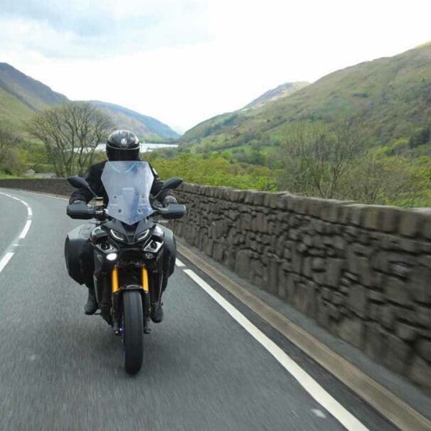 A motorcyclist enjoying cost-per-mile insurance - currently onyl a thing in the UK. Media sourced from VisorDown.