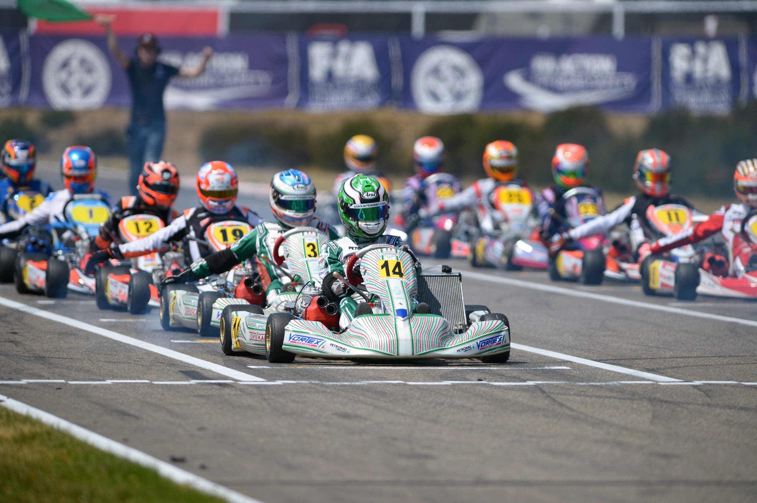 Group of go-kart drivers wait to begin a championship race