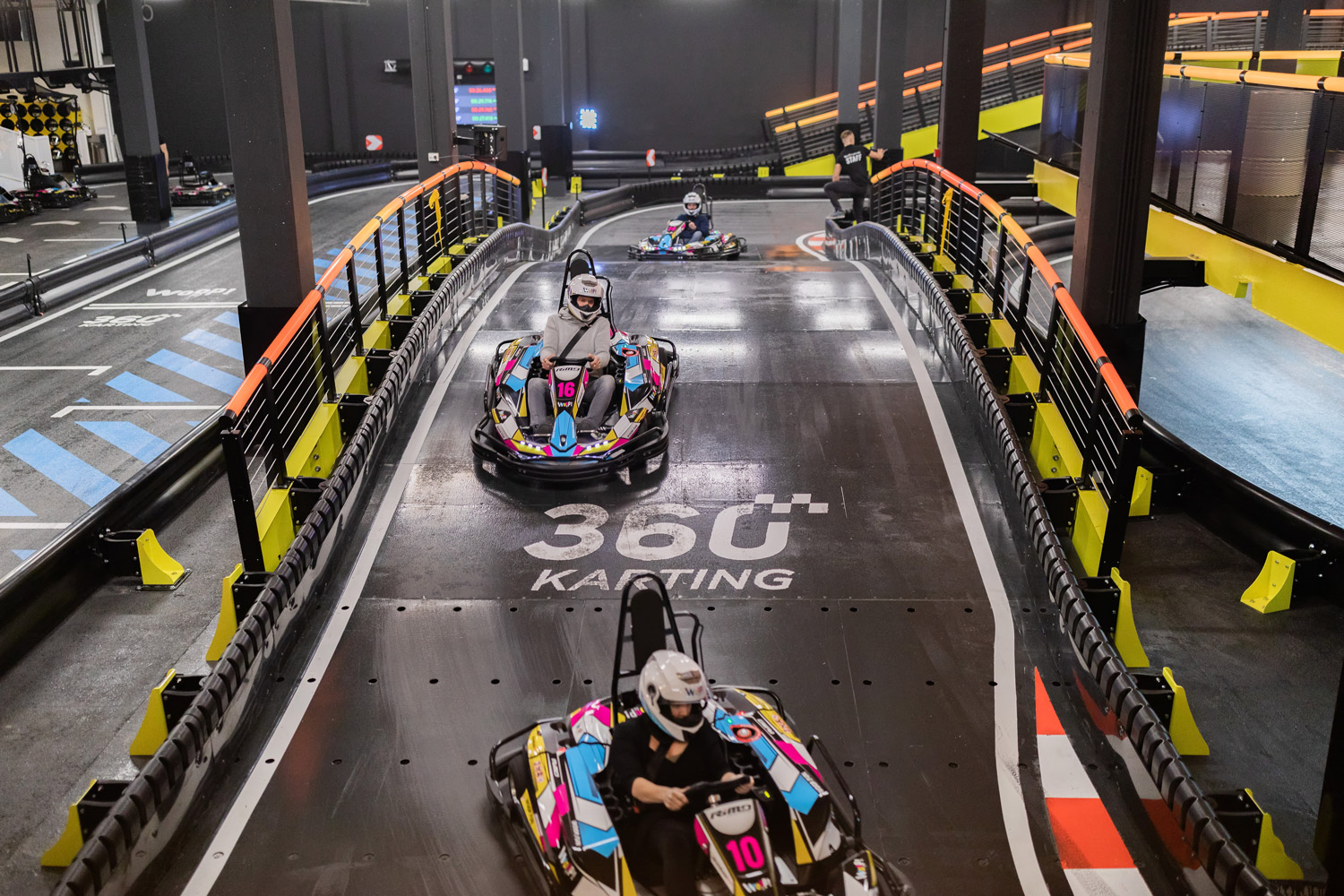 Group of drivers enjoying an indoor E-karting experience