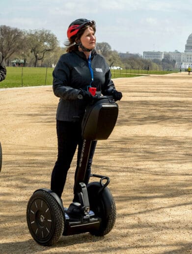 Couple riding Segway personal transporters through Washington State Park