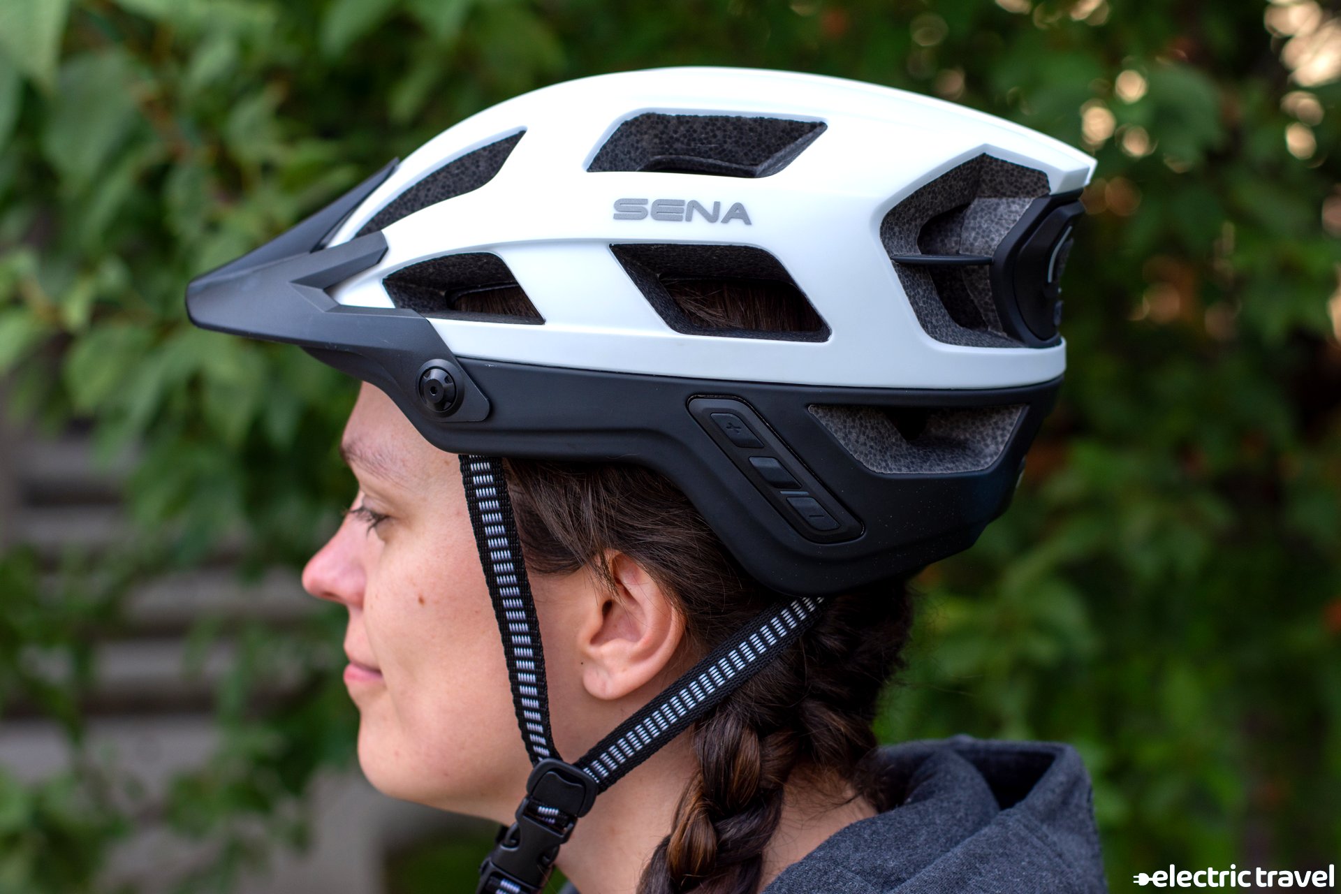 Side of SENA M1 Bluetooth helmet worn by woman