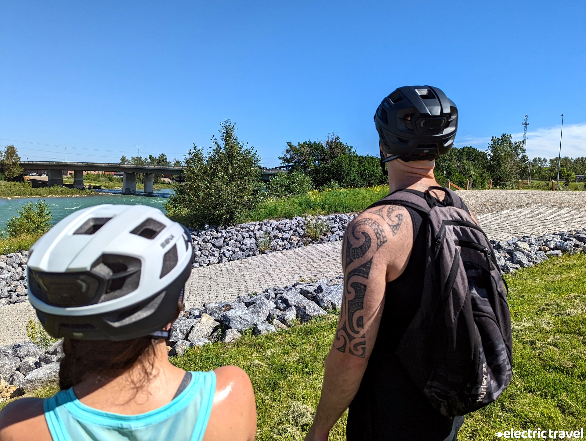 SENA M1 Bluetooth helmet worn by woman standing next to man near trail