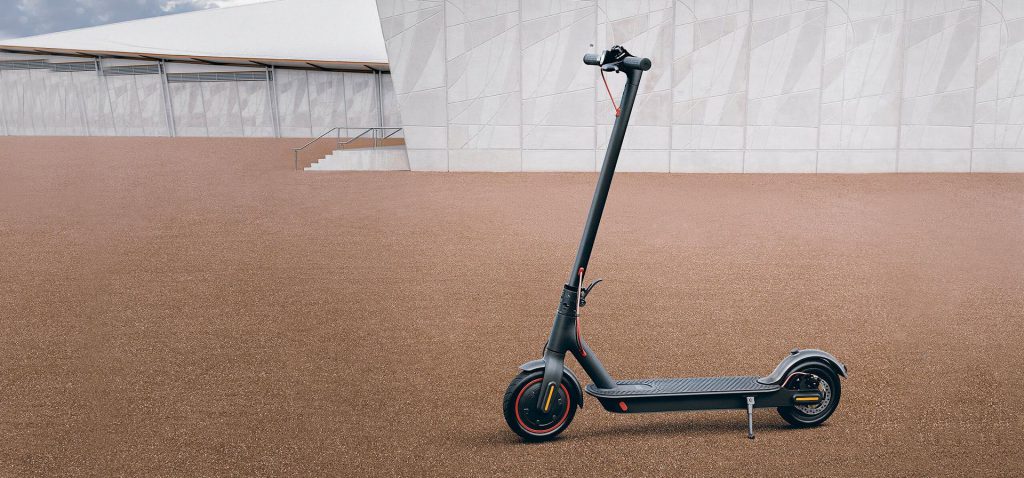 Xiaomi Mi electric scooter on gravel resting on kick stand