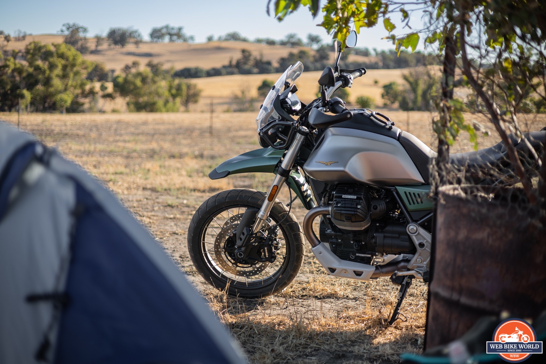 Left side photo of a 2021 Moto Guzzi V85TT Centenario and trees