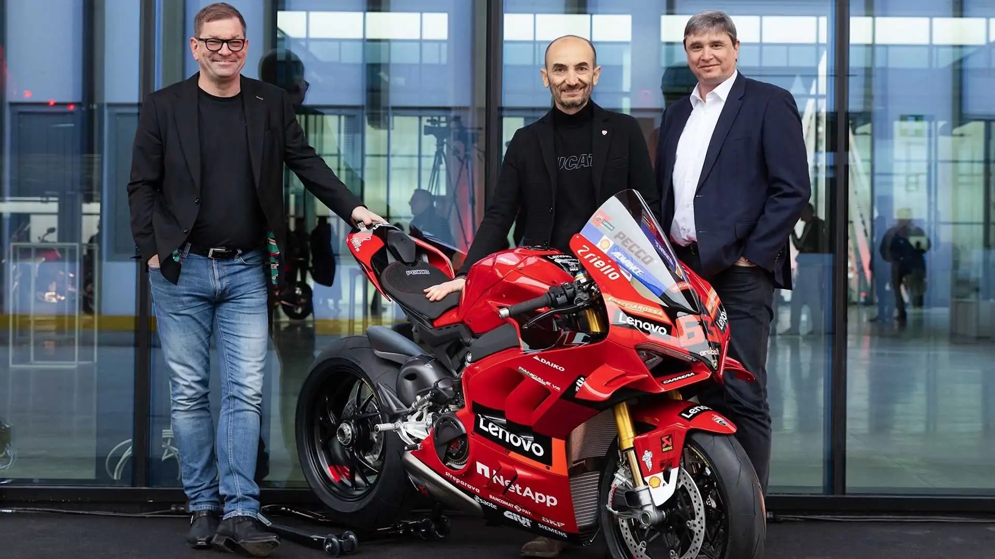 Claudio Domenicali next to Ducati's all-new eco-friendly building, the Finitura e Delibera Estetica. Media sourced from RideApart.