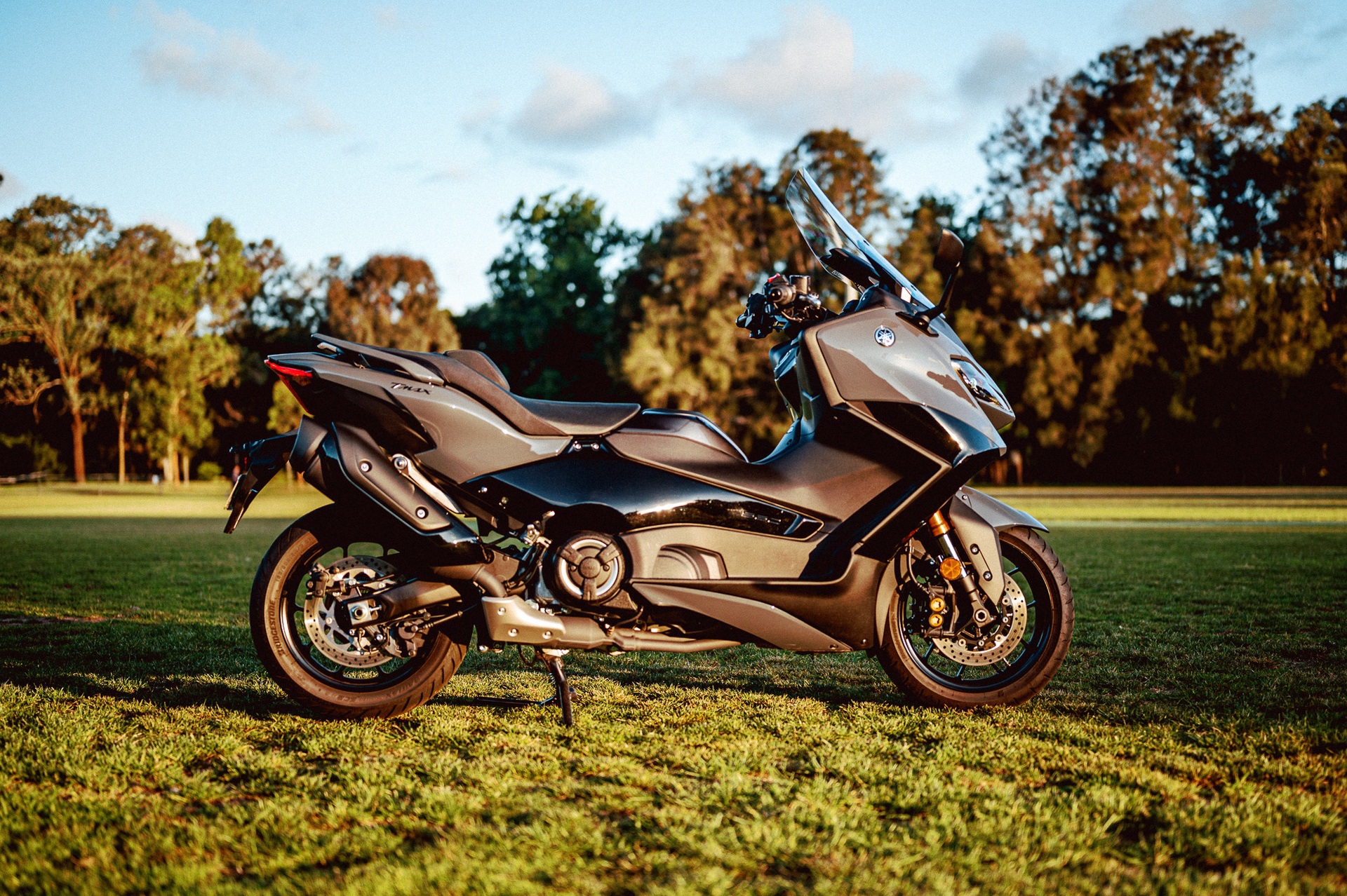 A 2022 Yamaha TMAX Tech MAX Scooter outside at sunset
