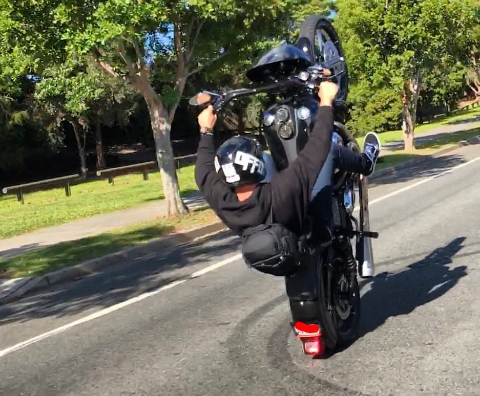 Police are seeking this Gold Coast rider performing a wheelie on a public road stunts