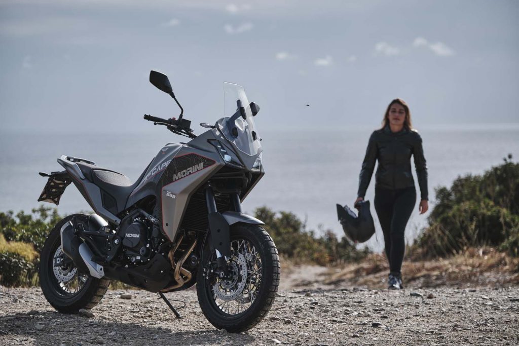 A view of a rider trying out the all-new Moto Morini X-Cape adventure motorbike on rugged terrain, with a gorgeous tropical view.