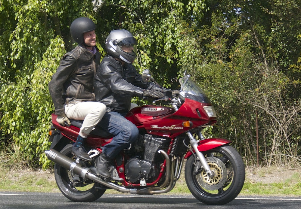 RACQ spokesman Steve Spalding takes Road Safety Minister Mark Bailey for a ride on his Bandit national