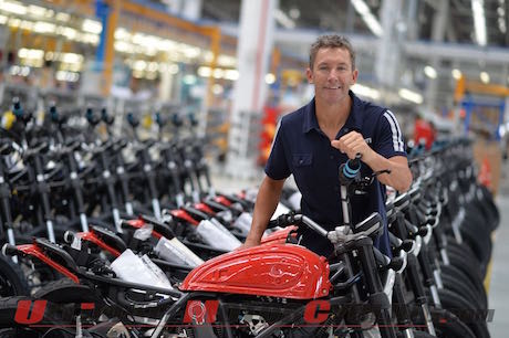 Troy Bayliss checks Ducati Scramblers dirt tracker workers