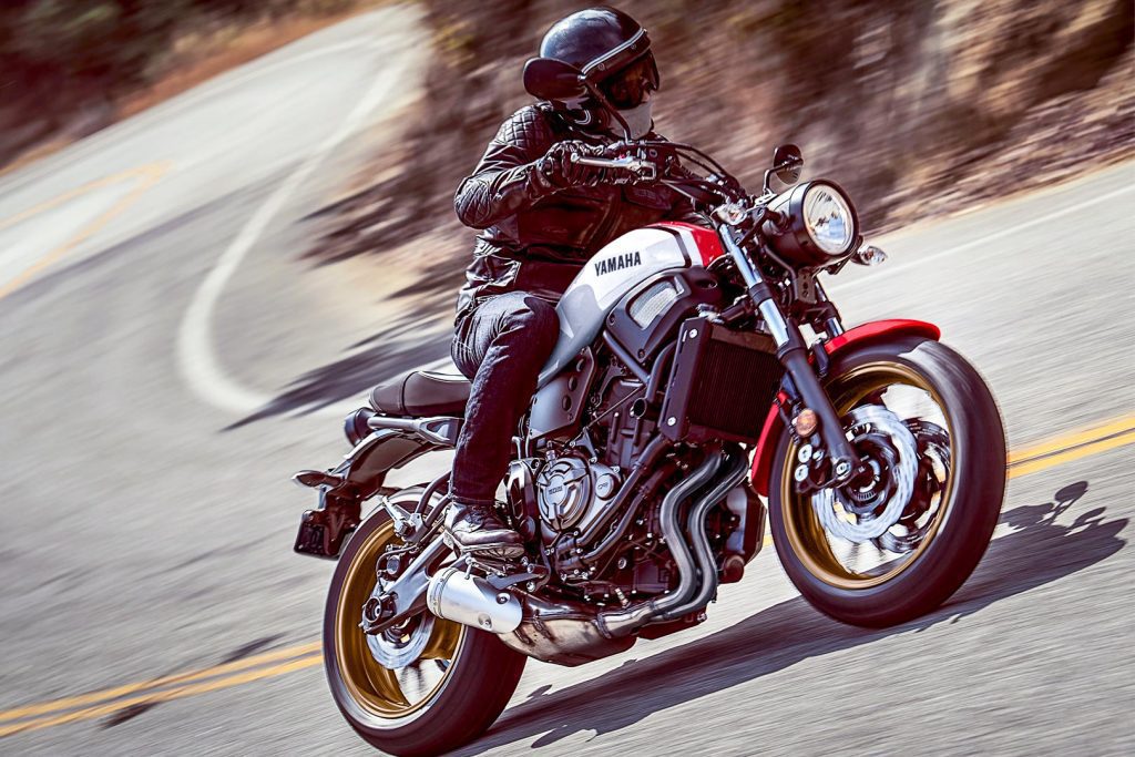 a side view of a rider turning a The Yamaha 2020 XSR700