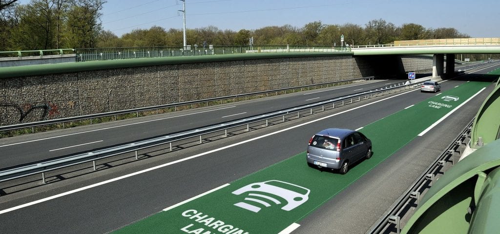 a car travelling along an inductive highway for a quick charge.