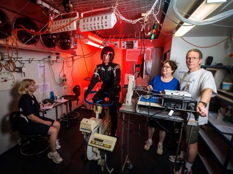 Testing motorcycle in the thermal chamber (from left) research assistant Liz Taylor, volunteer rider Dr Greg Peoples, Liz de Rome and Nigel Taylor. rating