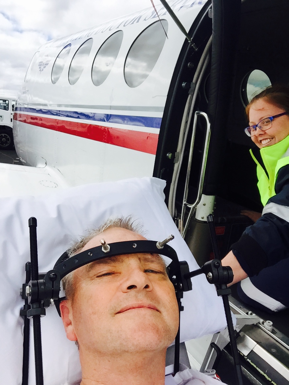 Andrew being loaded on by our flight nurse Jamie Corbett Flying Doctors