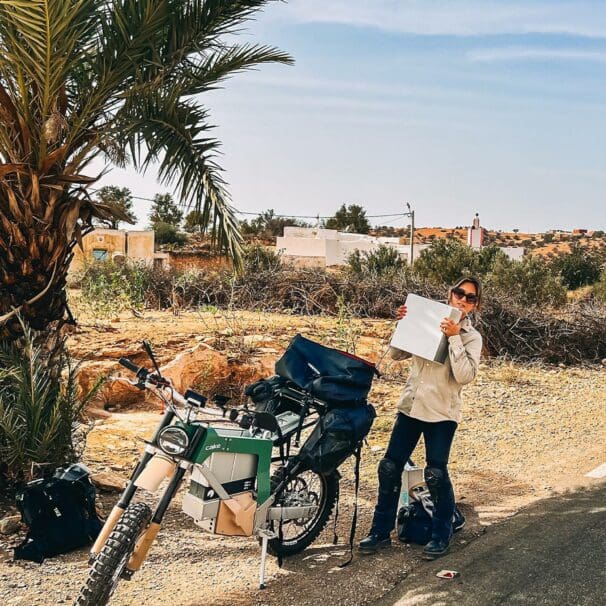 Sinje Gottwald, CAKE’s sales/account manager, beside a Kalk as she breaks a new record for "longest distance ever on an electric motorcycle." Media sourced from CAKE's Facebook page.