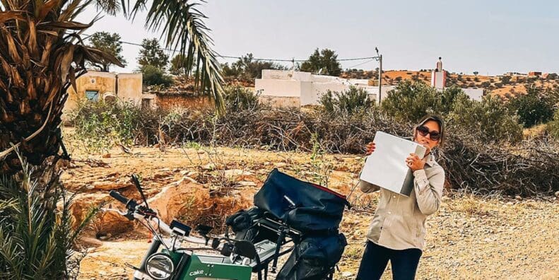 Sinje Gottwald, CAKE’s sales/account manager, beside a Kalk as she breaks a new record for "longest distance ever on an electric motorcycle." Media sourced from CAKE's Facebook page.