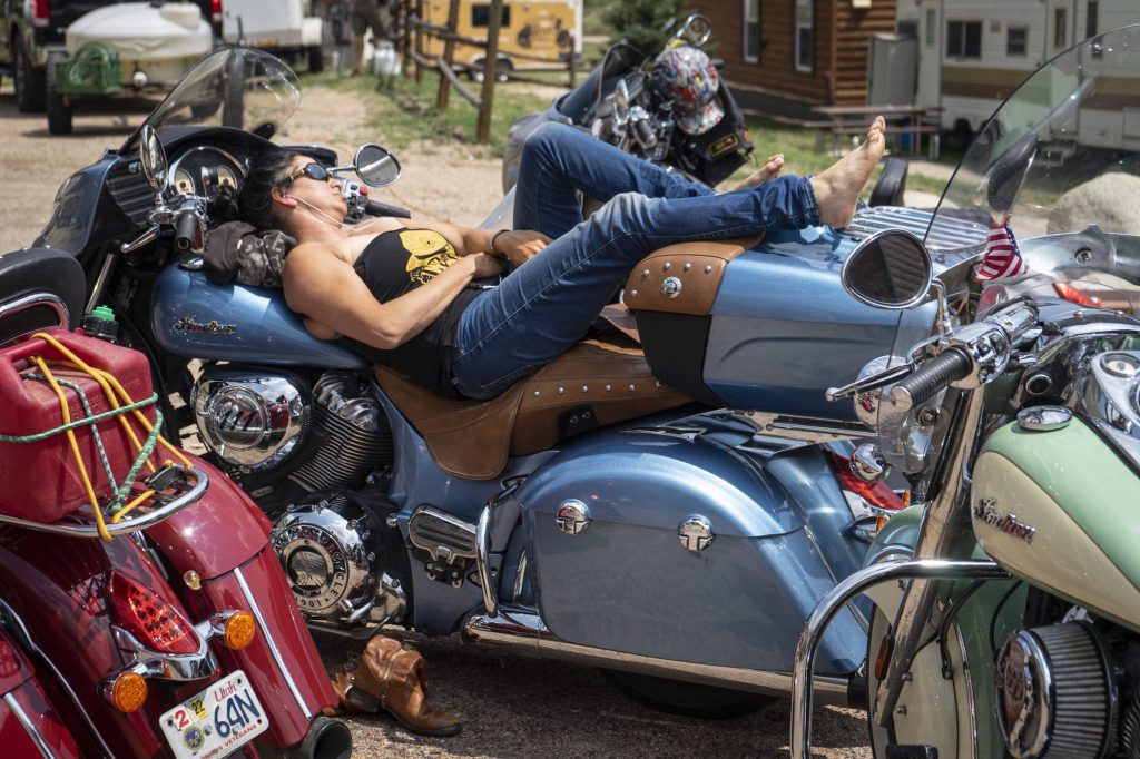 A female motorcyclist with her feet up, enjoying the view. Photo courtesy of Coffee or Die Magazine