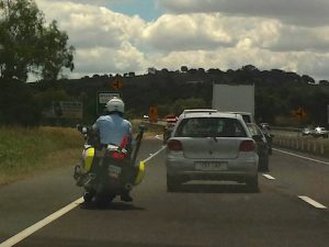 Queensland cop takes his feet off the motorcycle footpegs