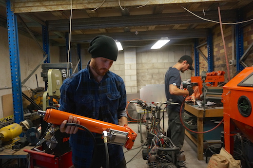 Aaron with tube bender at community motorcycle garage