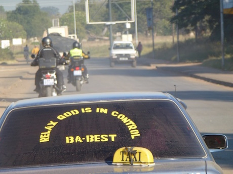 Peter on a 140km/h speed limit "highway" in Zambia - speedo gazing