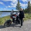 Female rider standing next to motorcycle wearing Daytona Travel Star Boots