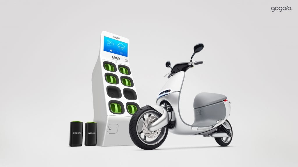 A Gogoro smart scooter next to a Gogoro battery-swapping station