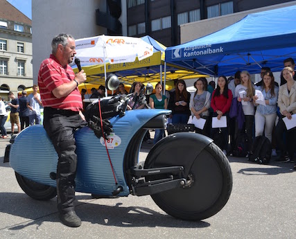 Jean Pierr Kessler addresses an crowd about the Johammer electric motorcycle in last year's WAVE Trophy eletric vehicle rally