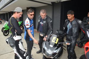 Dylan Code passes on tips to riders Josh McHenry, Richard Plihta and Malcom Henriques 