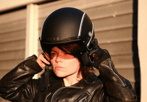 Nexx X60 Vintage Helmet being put on by Woman biker