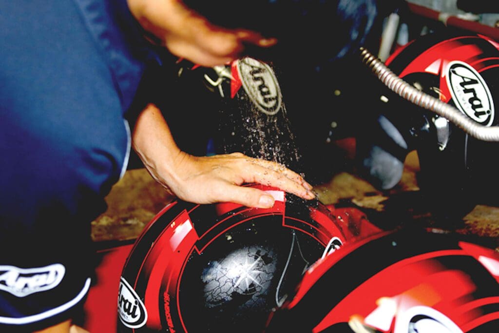 Arai's workshop, mid-helmet production. Media sourced from Arai.