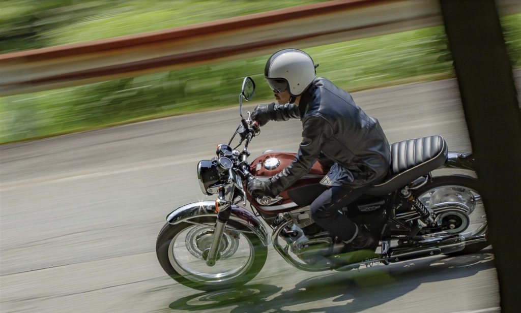 a rider enjoying the 2022 Kawasaki W800 leaning into the twisties